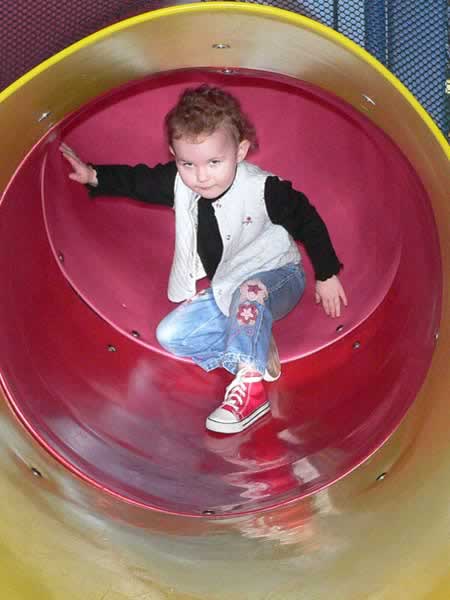 Sydney playing on a slide set