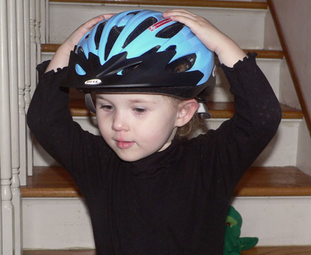 Sydney tries on Bean's bike helmet.