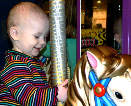 Maddox rides the merry-go-round.