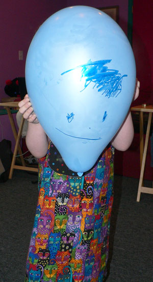 Sydney displays a balloon she drew on.