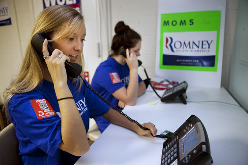 Shannon Westfield, 20, left, and Jane Kernan, 16, make calls for the Romney campaign while wearing quick response code stickers, known as QR codes, in Fairfax, Va., on Tuesday, June 19, 2012. The presidential ground game has gone high tech, marrying old-school organizing work with innovative digital tools. The T-shirts that Romney campaign volunteers wear in Virginia feature a digital code that voters can zap with their smart phones to learn more about the Republican presidential hopeful, which gives Romney field organizers valuable information on how to reach them in the future. (AP Photo/Jacquelyn Martin)